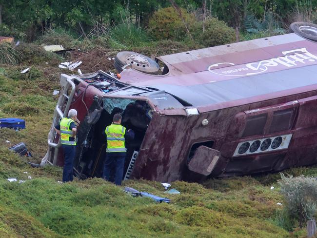 MELBOURNE, AUSTRALIA- SEPTEMBER 21 A school bus carrying 32 people has flipped on the Western Highway in Bacchus Marsh. Police are investigating the crash between a school bus and a truck that occured at around 3.15am. Picture: Brendan Beckett