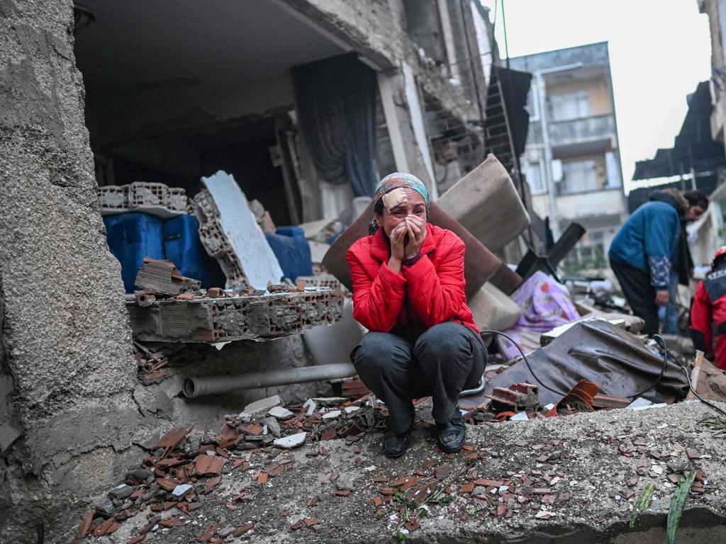 An earthquake survivor breaks down as rescuers search through the rubble in Hatay, Turkey. Picture: AFP