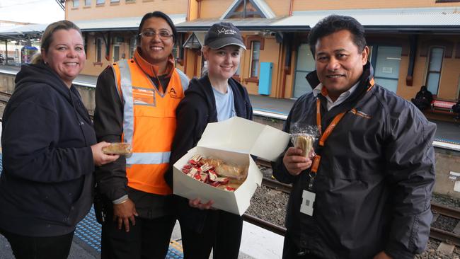 Waminda Bakery staff handing out free pies and sausage rolls to people travelling to work as part of Do Something Day at Campbelltown Station. Picture: Ian Svegovic