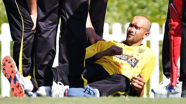 Ashton Agar of the Warriors is after being hit in the head while fielding.