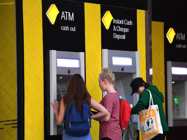 Customers use a Commonwealth Bank (CBA) ATM in Brisbane, Thursday, August 3, 2017. The Commonwealth Bank has been accused of a systemic failure to comply with anti-money laundering and counter-terrorism financing laws. The federal government's financial intelligence unit AUSTRAC on Thursday launched civil penalty proceedings in the Federal Court, accusing the lender of more than 53,700 contraventions of law. (AAP Image/Dan Peled) NO ARCHIVING