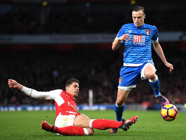 Gabriel of Arsenal (L) tackles Brad Smith of AFC Bournemouth (R).