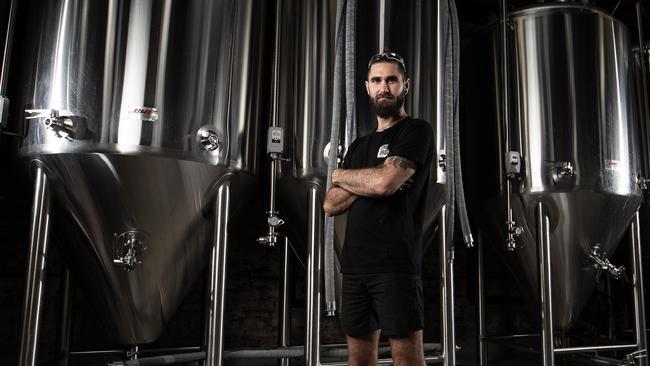 Nick Calder-Scholes, head brewer at One Drop Brewing in Botany, has turned his craft beer micro-brewery into a hand sanitiser production facility. Picture: Mark Metcalfe/Getty Images.