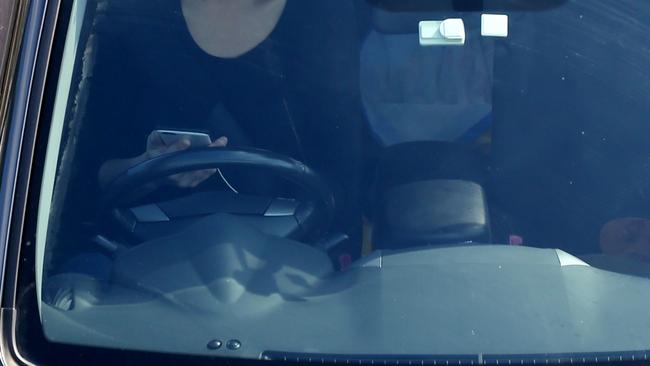 A driver checks her phone on Warringah Freeway in North Sydney. Picture: John Grainger