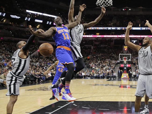 New York Knicks guard Jerian Grant is fouled as he drives by San Antonio’s Patty Mills.