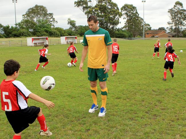 Emerton at a coaching clinic with junior players from Gunners Soccer Club at Macquarie Fields in 2011.