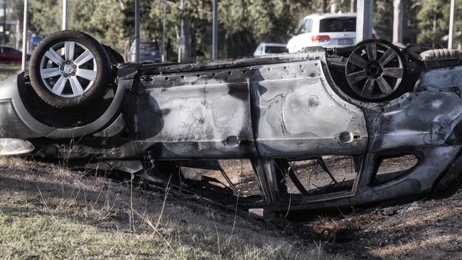 The trashed car left abandoned on the roadside at Belivah.