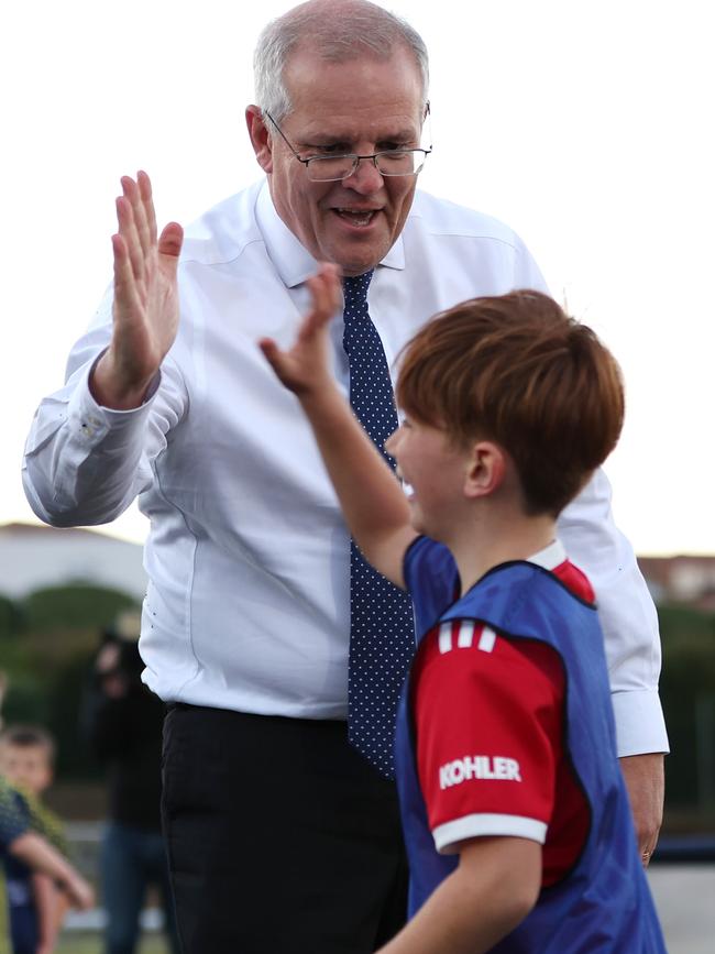 Luca high-fives the PM after they dusted themselves off and got back up. Picture: Asanka Ratnayake/Getty