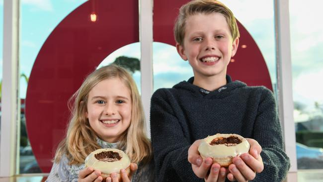 Ben Swan’s kids Bobbie, 9 and Cooper, 10 try the hot chocolate filled doughnut cup. Picture: Penny Stephens