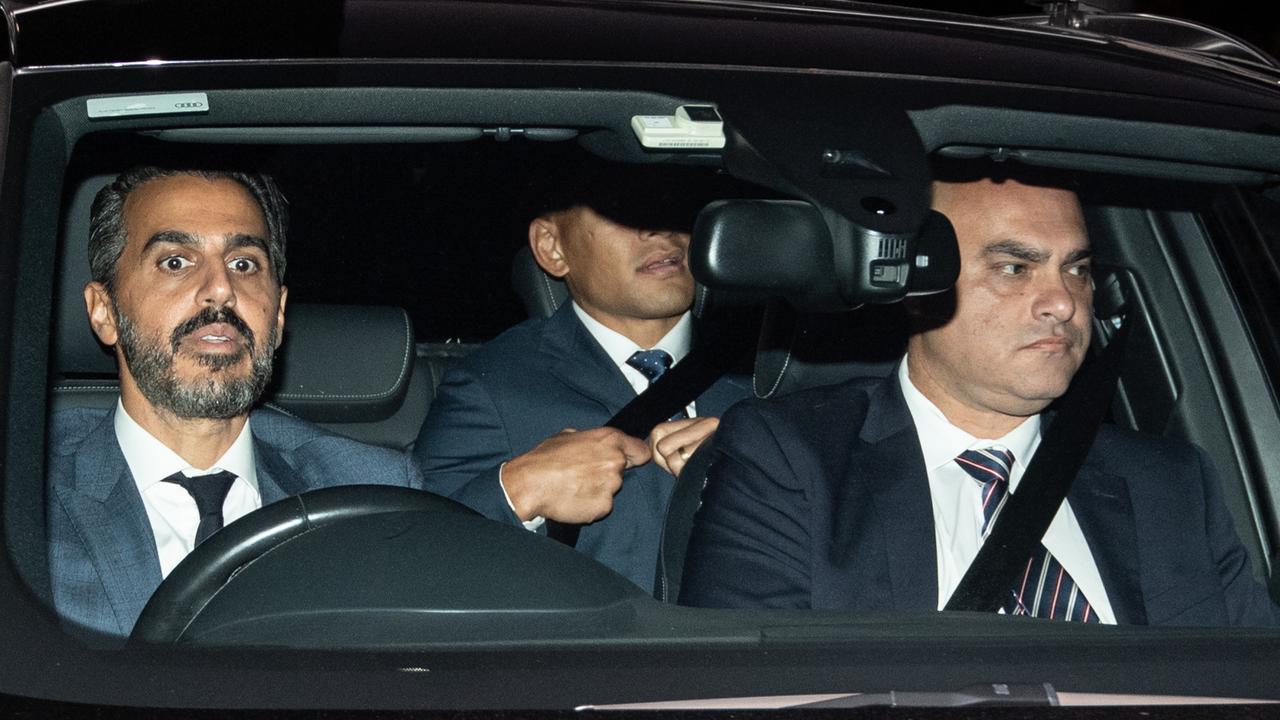 Israel Folau, centre, pictured in the back seat leaving the hearing at Rugby Australia.
