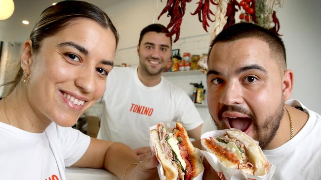 Owners, Anna Lisa and Nicholas Barone, and Anna Lisa’s husband, Stylianos Triantafyllidis with one of their specialty sandwiches. Picture: Dean Martin