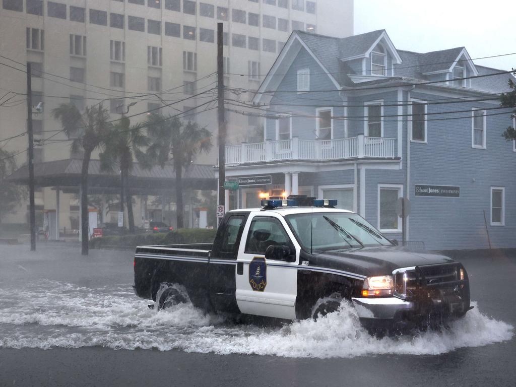 A police vehicle drives down a flooded street as rain from Hurricane Ian drenches the city on September 30, 2022 in Charleston, South Carolina. Picture: AFP