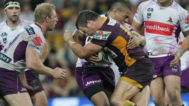 Broncos forward Ashton Sims takes on the Storm defence.