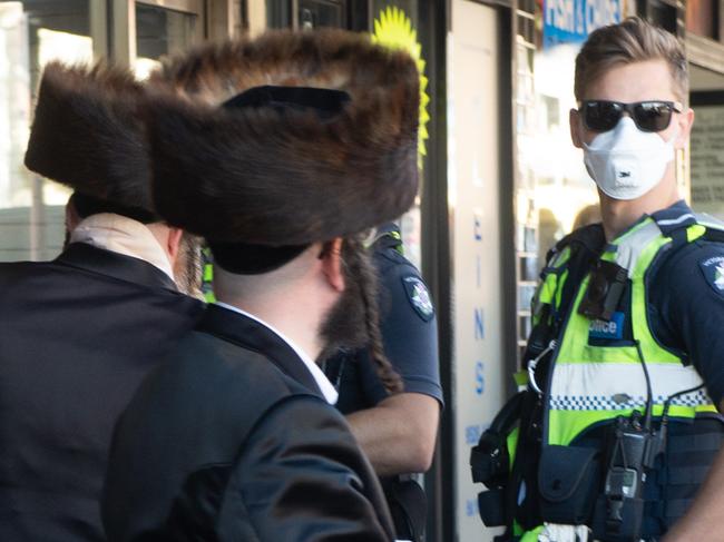 Police fine members of a Jewish Synagogue that have broken the Social distancing rule in Glen Eira road, Ripponlea. Picture: Tony Gough