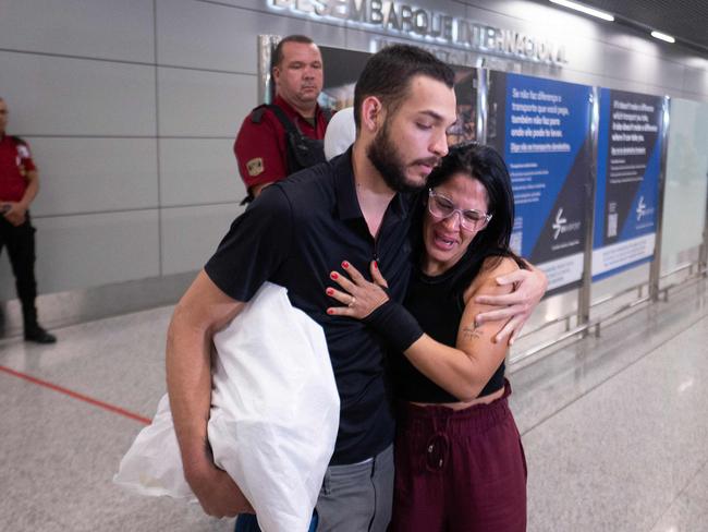 Brazilian Luis Antonio Rodrigues Santos is welcomed by Eliana Campos after being deported from the US. Nearly 80 Brazilian illegal migrants deported from the US were handcuffed during the journey. Picture: AFP