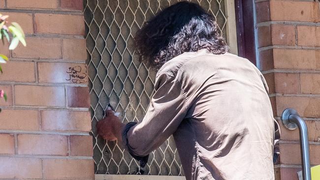 A man injects in a car park next to the Richmond safe injecting room. Picture: Jason Edwards