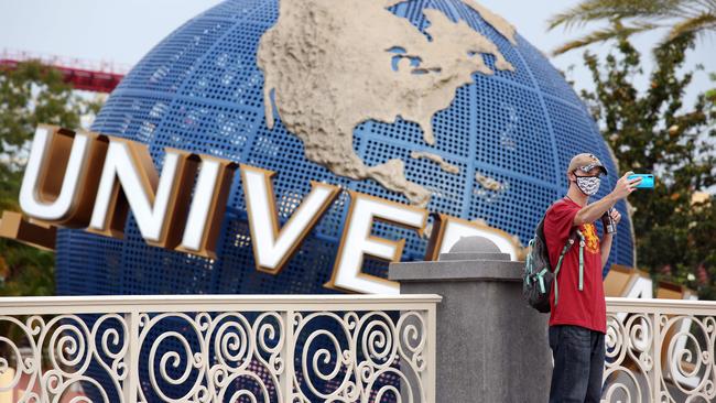 A visitor takes a selfie at Universal Studios theme park in Florida on the first day of reopening on Friday. Picture: AFP