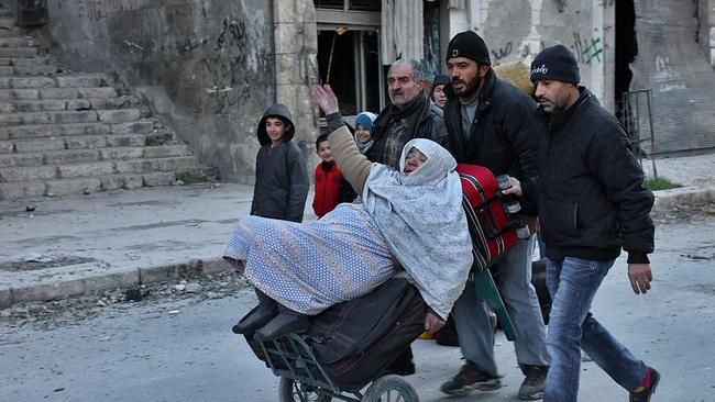 Syrian residents fleeing the violence in the eastern rebel-held parts of Aleppo evacuate from their neighbourhoods after it was seized by the government forces in December 2016. Picture: George Ourfalian/AFP Photo