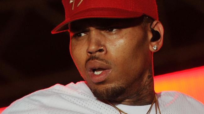 (FILES) This file photo taken on June 26, 2015 shows singer Chris Brown performing during a free concert in Champ de Mars, downtown Port-au-Prince, Haiti.  A Los Angeles woman filed a lawsuit on Wednesday, May 9, 2018 against Chris Brown and a fellow rapper, alleging she was repeatedly raped and sexually assaulted at Brown's home during a drug- and alcohol-fueled party last year. The woman, identified only as Jane Doe, said she was lured to the singer's house following a concert at a nightclub on February 23, 2017 and was raped several times by Lowell Grissom, who performs under the name Young Lo.  / AFP PHOTO / Hector RETAMAL