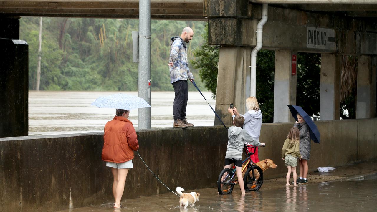 Heavy rain continues to batter the NSW mid north coast causing major flooding. Kempsey residents check the water levels at the towns levy wall . Nathan Edwards