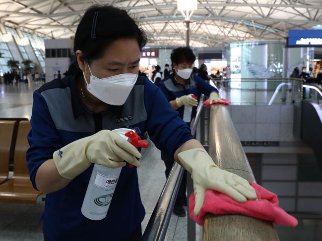 Disinfection workers spraying antiseptic solution at the Incheon International Airport in Incheon, South Korea, to ensure visitors and those passing through are safe from the coronavirus. Picture: Chung Sung-Jun/Getty