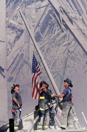 Firefighters raise the American flag among the wreckage of the World Trade Centre on September 11, 2001. AP