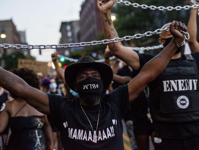 MINNEAPOLIS, MN - JULY 04: Demonstrators carry chains during the Black 4th protest in downtown on July 4, 2020 in Minneapolis, Minnesota. A number of protest demonstrations occurred around the Twin Cities on Independence Day which were critical of the annual American celebration.   Stephen Maturen/Getty Images/AFP == FOR NEWSPAPERS, INTERNET, TELCOS & TELEVISION USE ONLY ==