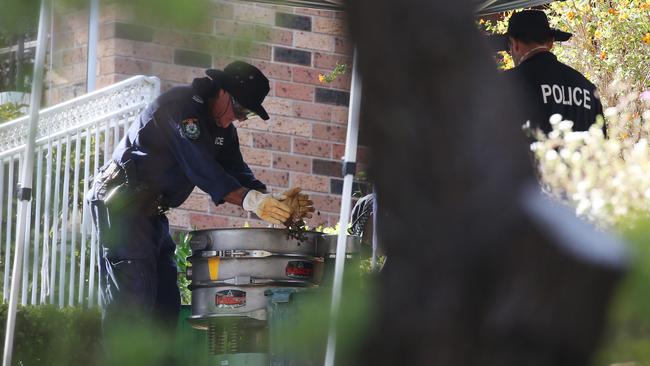 Police sort through dirt from near the pool area on day two of the forensic search at the former home of Lynette Dawson's at Bayview. Picture: Hollie Adams