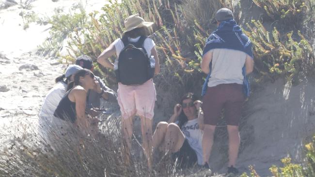 A group of people at Mary Ellis Beach, where Dan Cojecea has gone missing in the water. Picture: Robert Lang