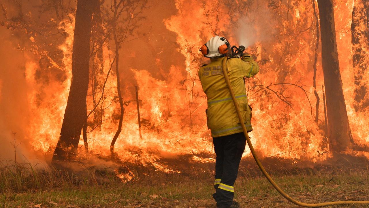 A firefighter conducts back-burning measures to secure residential areas from encroaching bushfires in the Central Coast. Picture: Saeed Khan/AFP