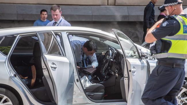 Police search the alleged offender’s car. Picture: Jason Edwards