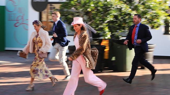 Racegoers run as the gates open during 2019 Melbourne Cup Day at Flemington. Picture: Getty Images