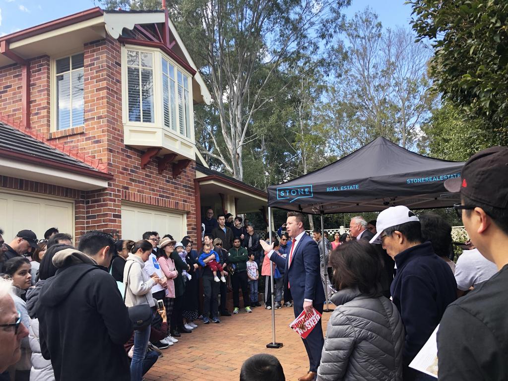 Crowds gather at the auction in Louise Way, Cherrybrook.