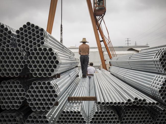 Workers prepare to lift bundles of steel pipe with a crane at a stockyard on the outskirts of Shanghai, China, on Thursday, July 5, 2018. U.S. President Donald Trump’s attempts to re-balance global trade have already sent the metals world into a tizzy. As countries respond to U.S. tariffs and sanctions, the disarray is set to increase. Photgrapher: Qilai Shen/Bloomberg