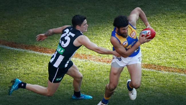 Josh Kennedy tries to evade Collingwood’s Jack Crisp in July. Picture: Michael Willson/AFL Media/Getty Images