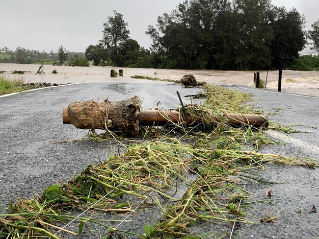 The cause way at Maudsland Drive Oxenford on the Gold Coast is totally blocked to all traffic due to high rising flood waters which have caused severe damage to fences and the road surface overnight. NCA NewsWire / Scott Powick