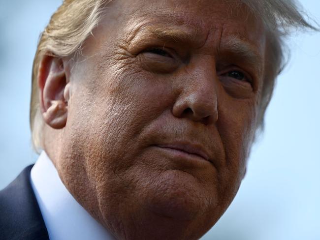 (FILES) In this file photo  US President Donald Trump speaks to the press as he departs the White House in Washington, DC on September 30, 2020. - President Donald Trump began his final full day in the White House on January 19, 2021 with a long list of possible pardons to dish out before snubbing his successor Joe Biden's inauguration and leaving for Florida. On January 20, 2021 at noon, Biden will be sworn in and the Trump presidency will end, turning the page on some of the most disruptive, divisive years the United States has seen since the 1960s. (Photo by Andrew Caballero-Reynolds / AFP)