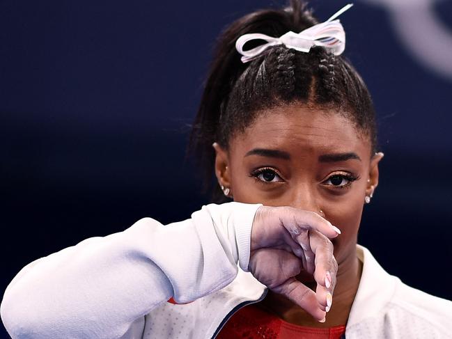 (FILES) In this file photo taken on July 27, 2021 USA's Simone Biles gestures during the artistic gymnastics women's team final during the Tokyo 2020 Olympic Games at the Ariake Gymnastics Centre in Tokyo. - Simone Biles withdrew from Olympics all-around gymnastics on July 28, 2021. (Photo by Loic VENANCE / AFP)