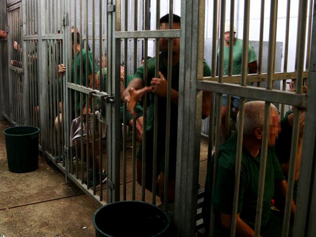 Inmates packed in together in one cell before being transferred to the processing centre. Picture: Adam Taylor