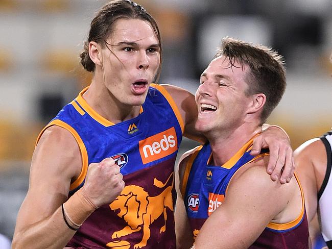 Lions players Eric Hipwood (left) and Lincoln McCarthy react after Hipwood kicked a goal during the Round 3 AFL match between the Brisbane Lions and Port Adelaide Power at the Gabba in Brisbane, Saturday, April 6, 2019. (AAP Image/Dave Hunt) NO ARCHIVING, EDITORIAL USE ONLY