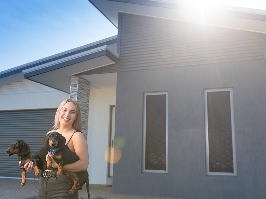 Kate Johnson with her two dogs Ollie and Bentley three weeks after moving in to her new home. Picture: Che Chorley