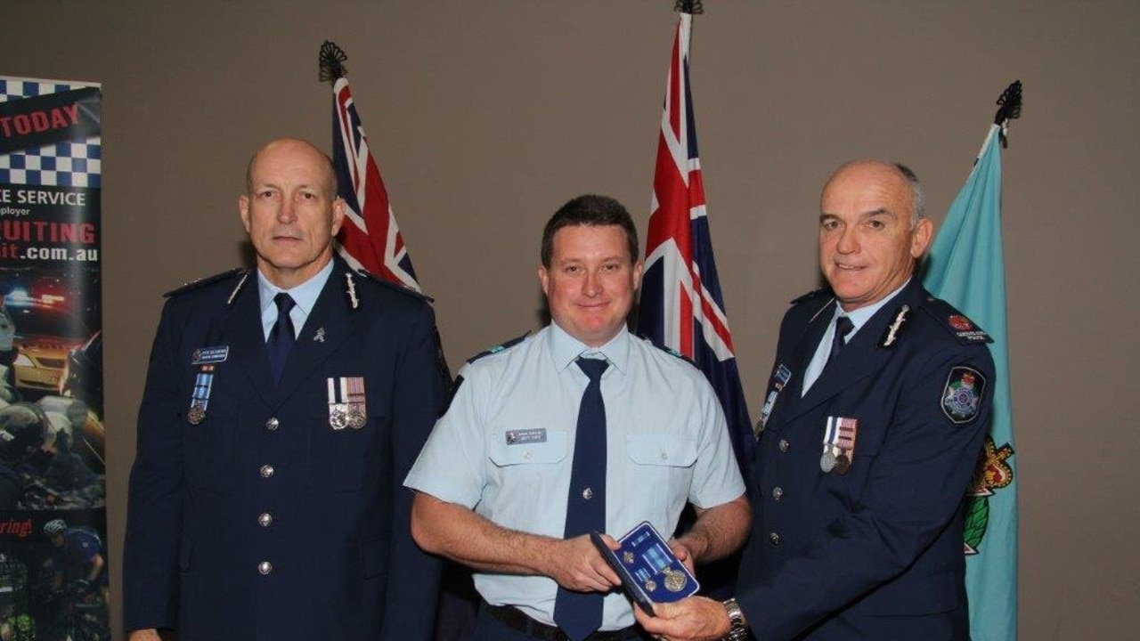 Senior Constable Brett Forte receiving a service medal during his time at Caboolture Police Station.