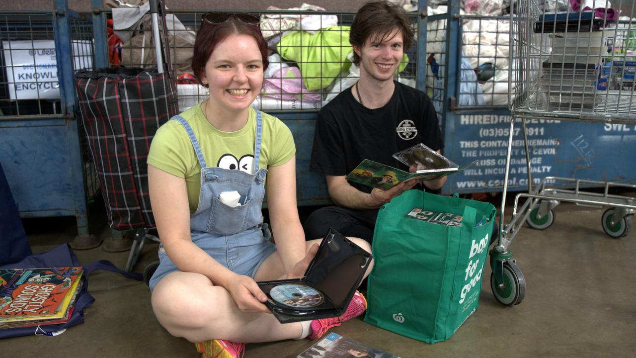 Tyra Morris (left) and Martin McCann sort through a stash of DVDs and video games to add to their collection at The Chronicle Lifeline Bookfest 2024 at Toowoomba Showgrounds, Saturday, March 2, 2024. Picture: Christine Schindler