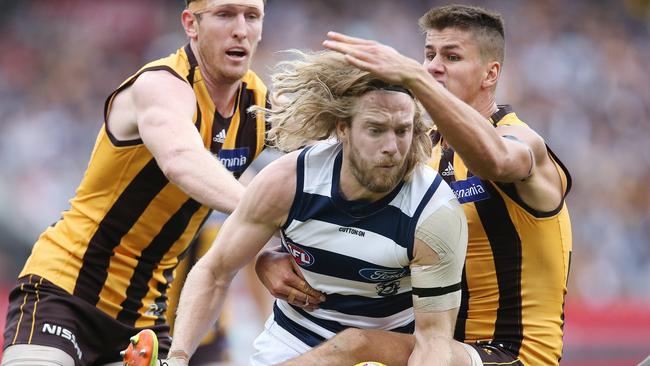 AFL Round 5. 22/04/2019. Hawthorn v Geelong at the MCG. Geelongs Cameron Guthrie under pressure from Hawthorns Daniel Howe and Ben McEvoy. Pic: Michael Klein.