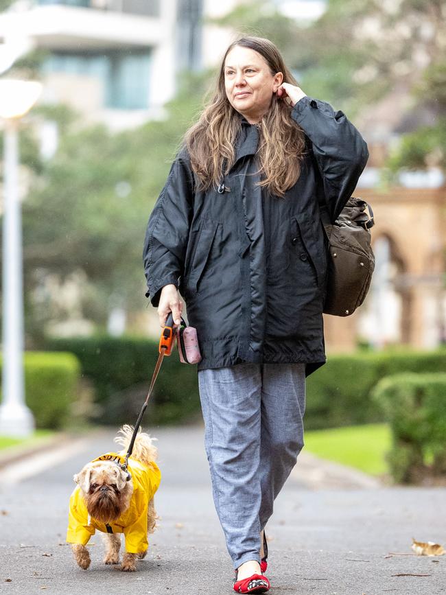 Jannette Pitkevica and Beppi were prepared for Wednesday’s weather change with Beppi wearing his custom raincoat. Picture: Thomas Lisson