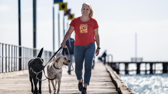 Labor candidate Peta Murphy for the seat of Dunkley walks her dogs on Frankston pier. Picture: Tony Gough