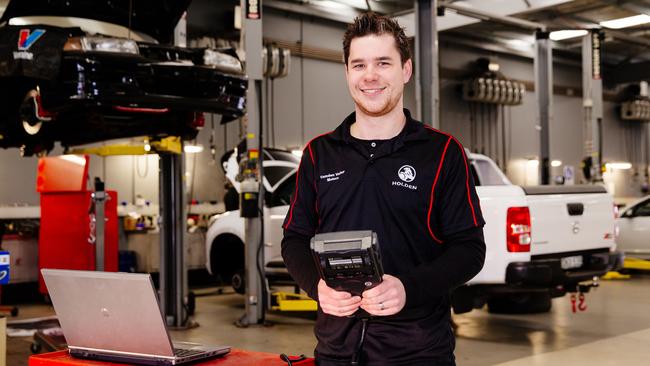 Mechanic Josh Ellacott using computer diagnostic equipment. Computers – not grease – are a common sight in modern workshops. Picture: Jonathan Ng