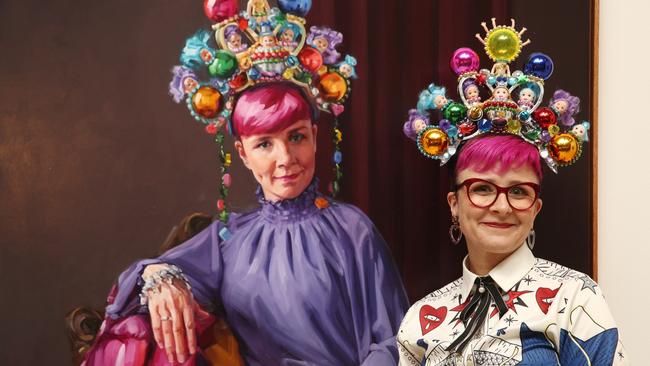 Cal Wilson poses beside Andrea Huelin's Packing Room Prize 2023 portrait of her titled 'Clown Jewels' during the 2023 Packing Room Prize announcement on April 27, 2023 in Sydney, Australia. Picture: Wire image