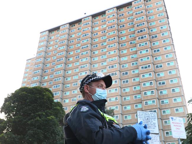 A police officer outside the Flemington towers. Picture: David Crosling