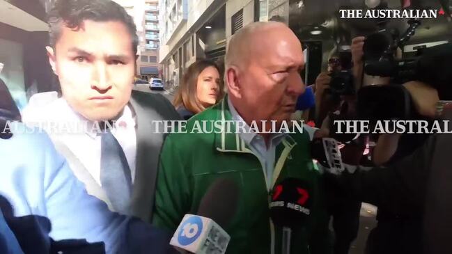 Alan Jones charged with historical offences, seen leaving police station